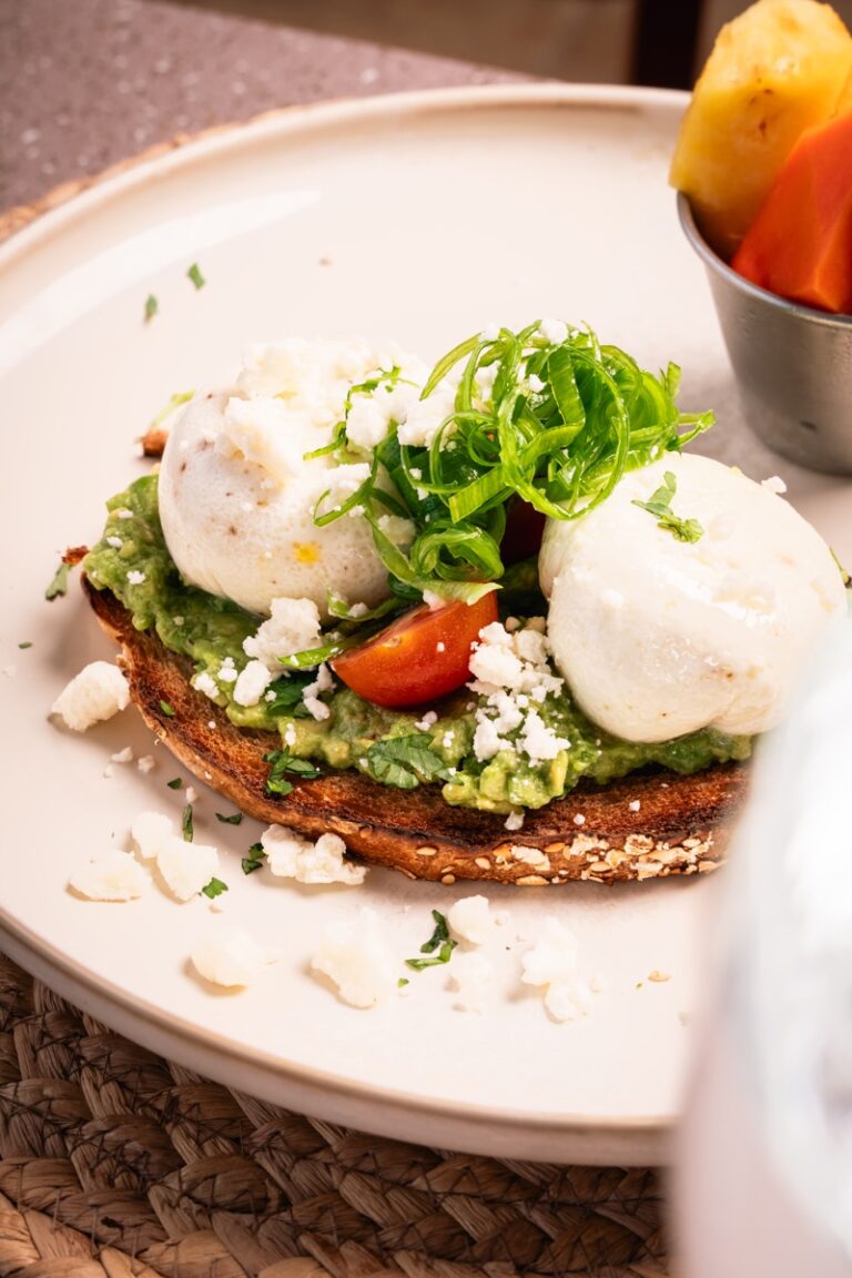 Avocado toast with poached eggs, feta and cherry tomatoes