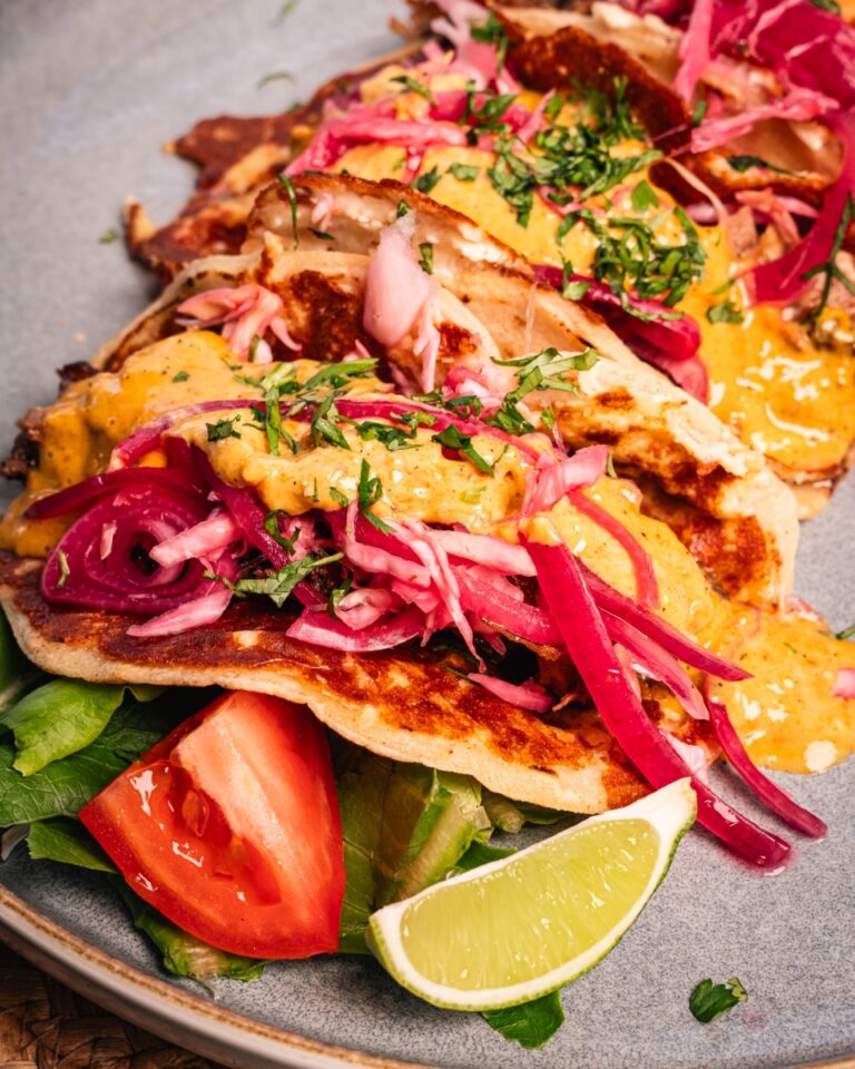 Beef tacos with pickled red onion, coriander and lime