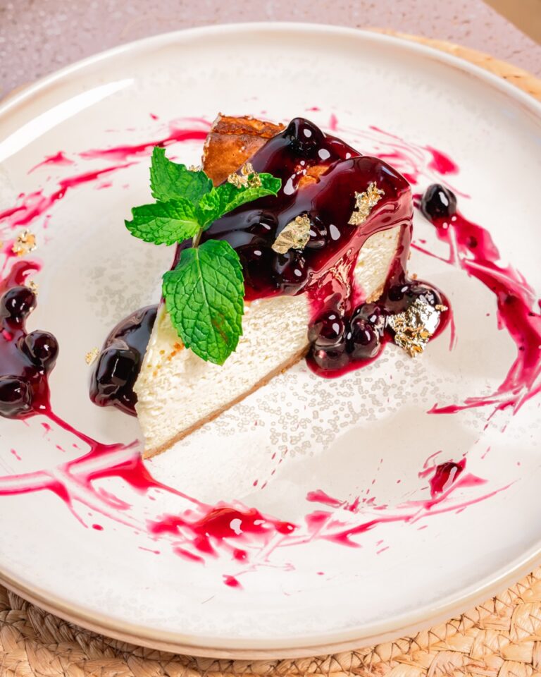 Cheesecake with berry sauce and fresh mint