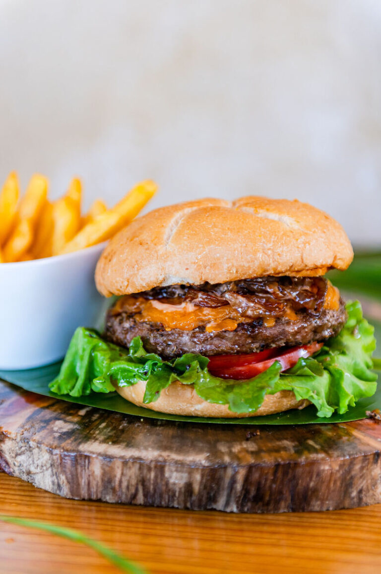 Chefs burger with beef and pork patty, cheddar and grilled onions, with french fries