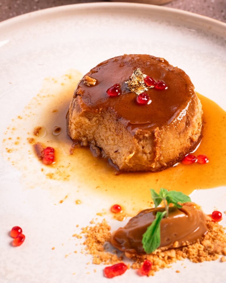 Coconut caramel flan with pomegranate seeds and dulce de leche