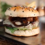 Fire grill bacon burger with cheddar and grilled onions at Fort Consolation