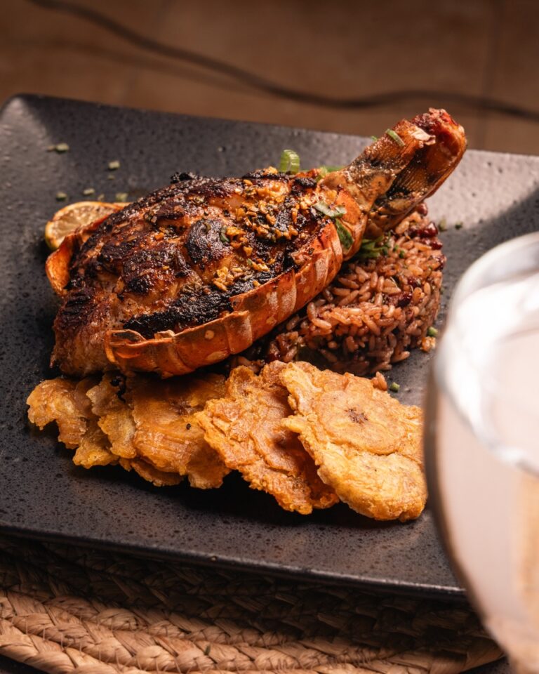 Grilled lobster tail with garlic butter, rice and tostones