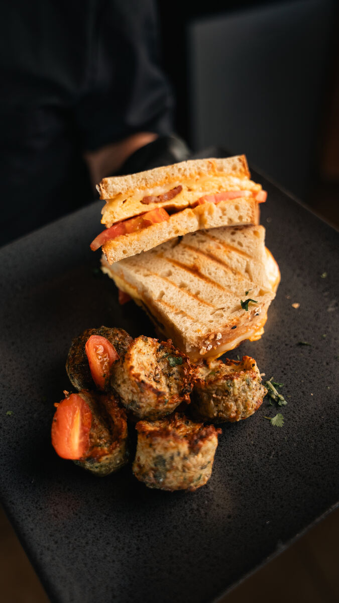 Toasted artisan bread sandwich with egg and chorizo, served with provencal potatoes