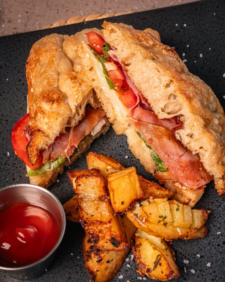 Prosciutto and caprese sandwich on focaccia with roasted potatoes
